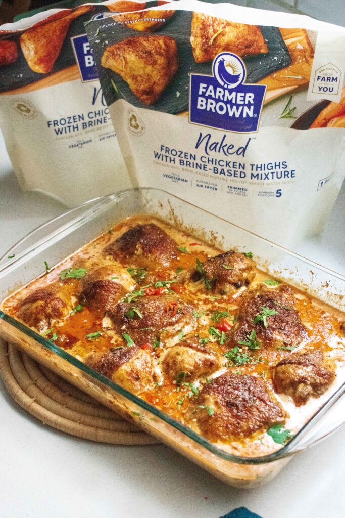 Baked peri-peri chicken on a plate. Farmer Brown Frozen Chicken baked in a saucy creamy sauce. this recipe is from Lila lerie from The Big Tasty Bite. She is a South African Foodie 