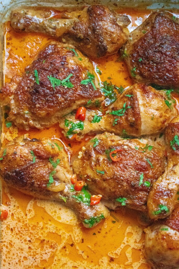 Baked peri-peri chicken on a plate. Farmer Brown Frozen Chicken baked in a saucy creamy sauce