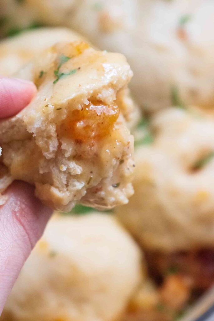 Lila Lerie from The Big Tasty Bite dipped a dumpling into the creamy chicken stew