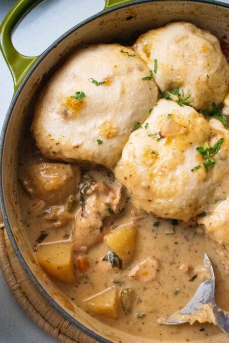 Creamy chicken stew topped with dumplings in a caserol