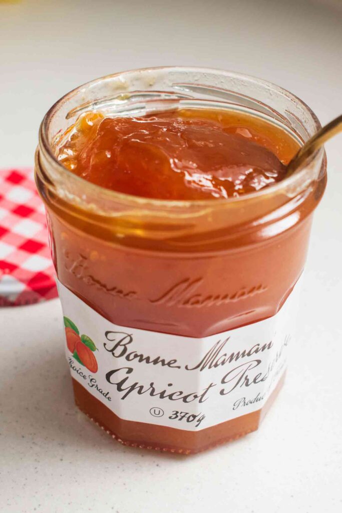 Bonne Maman Apricot Preserve in a jar with a spoon