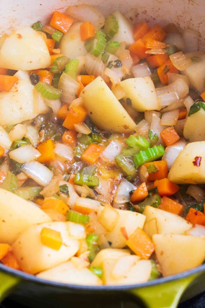 Simmering Diced onions celery and carrots for the creamy chicken stew with dumplings