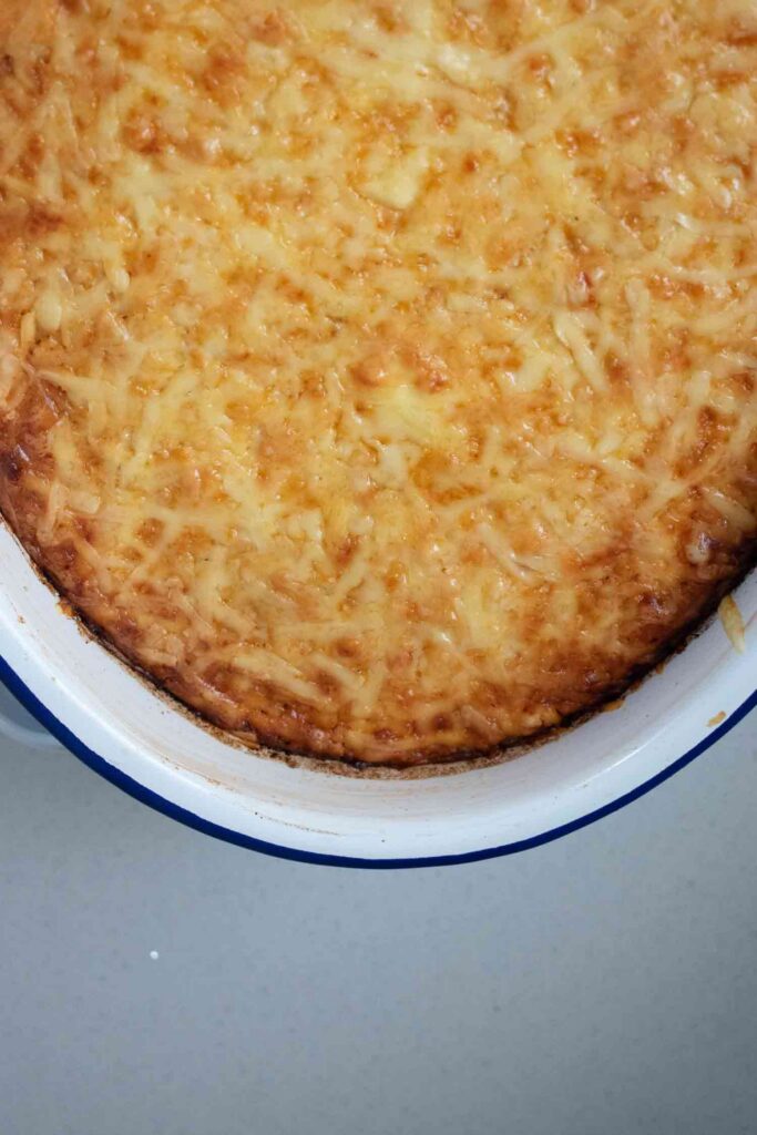 baked oven paptert with grated melted cheese on top